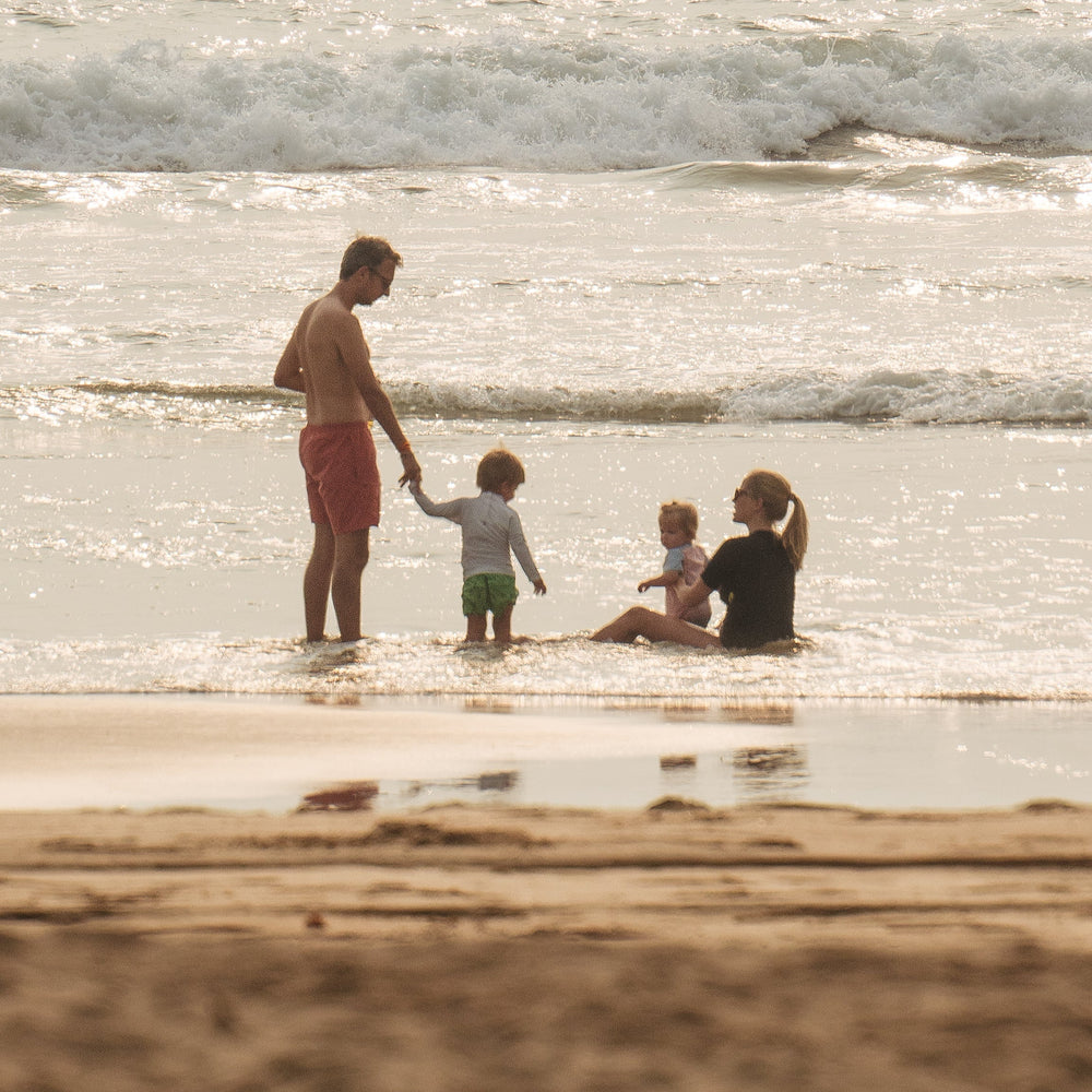 Family of founder Amelie Jageneau sitting at the beach.