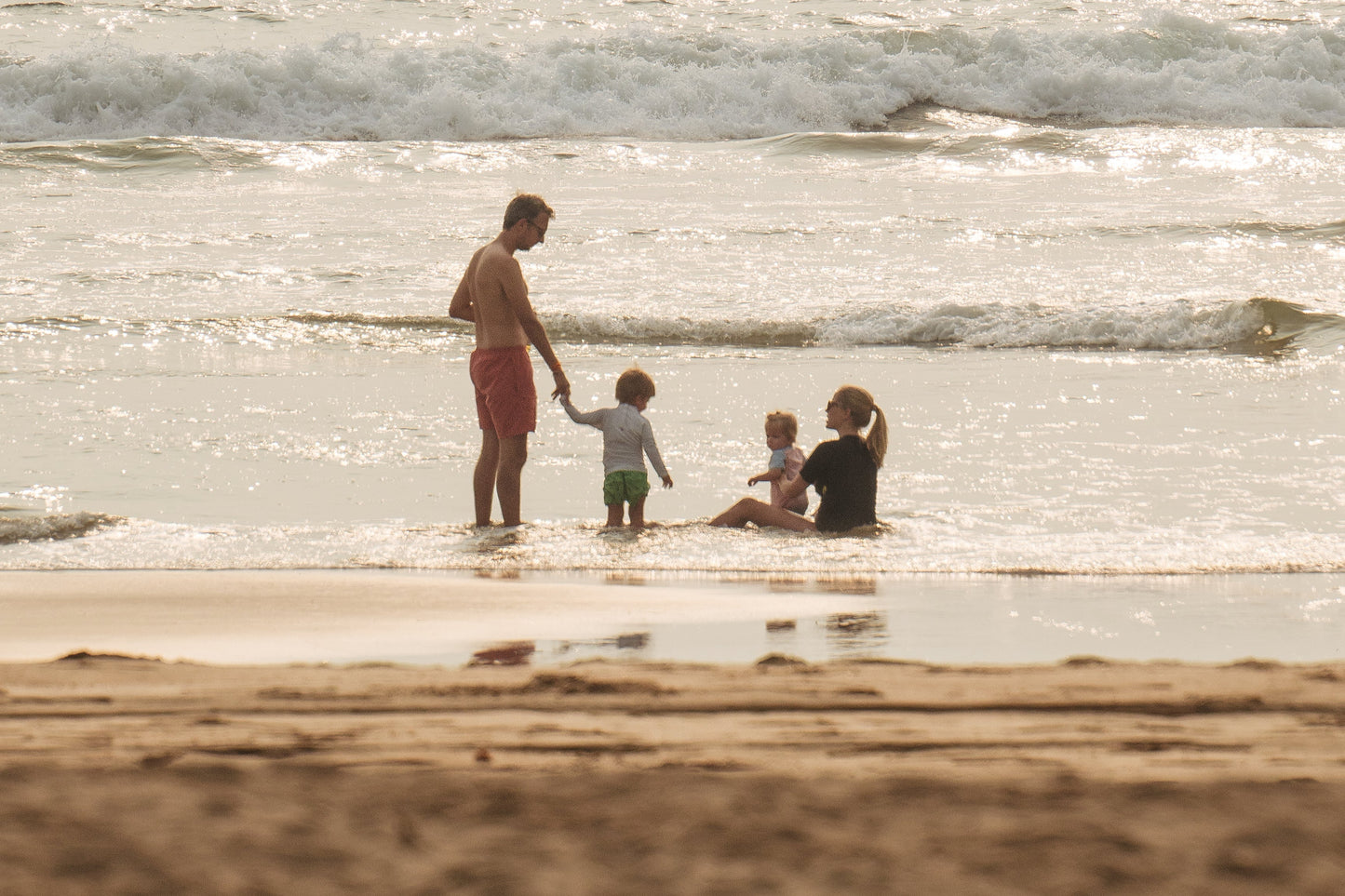 Family of founder Amelie Jageneau sitting at the beach.